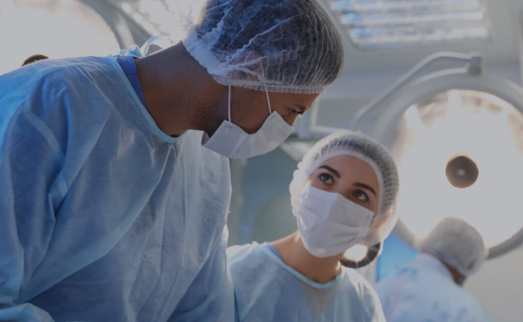 Two surgeons performing a surgical procedure schedule using the Qventus perioperative solution